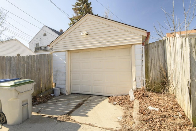 detached garage with driveway and fence