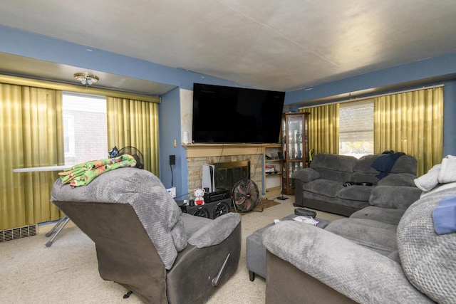 carpeted living room with visible vents and a fireplace