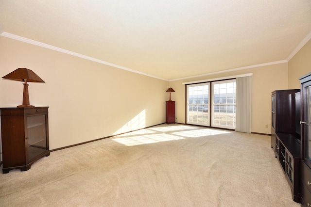 unfurnished living room featuring light colored carpet, baseboards, and ornamental molding