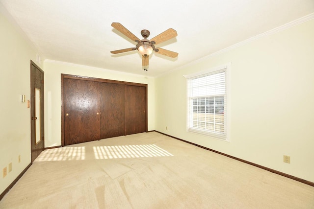 unfurnished bedroom featuring a closet, baseboards, and ornamental molding