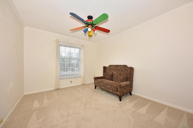 sitting room featuring baseboards, crown molding, carpet, and a ceiling fan