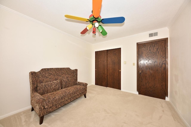 living area featuring visible vents, a ceiling fan, carpet flooring, crown molding, and baseboards