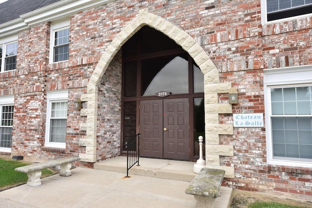 property entrance with brick siding