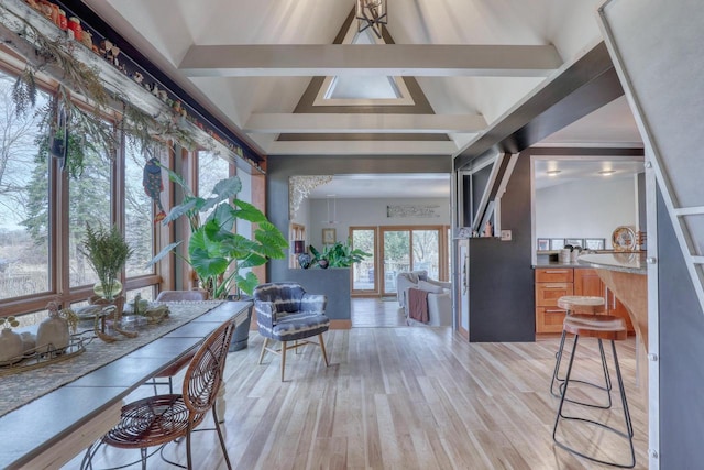 interior space with lofted ceiling with beams and light wood-type flooring