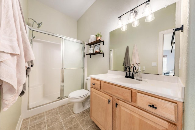 full bath featuring vanity, tile patterned floors, toilet, and a stall shower