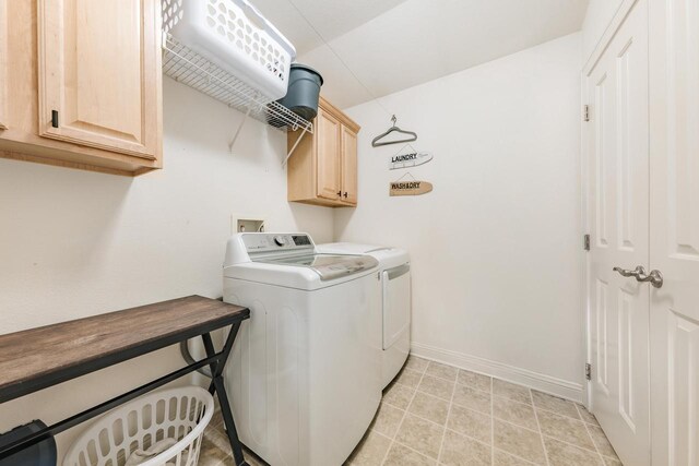 washroom featuring cabinet space, independent washer and dryer, and baseboards