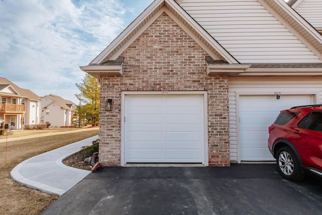 garage featuring aphalt driveway