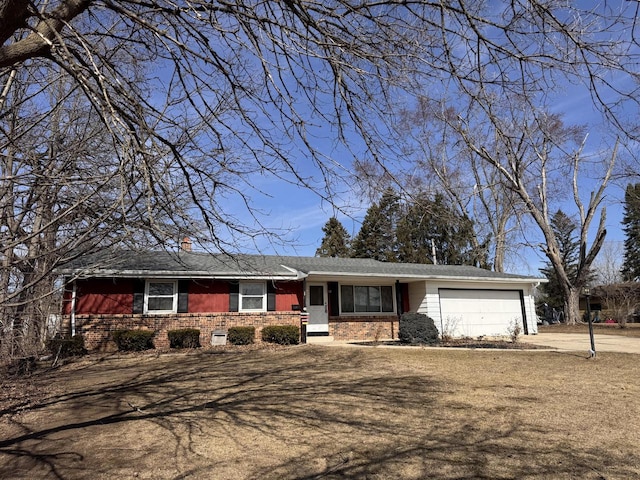 ranch-style home with brick siding, an attached garage, and driveway