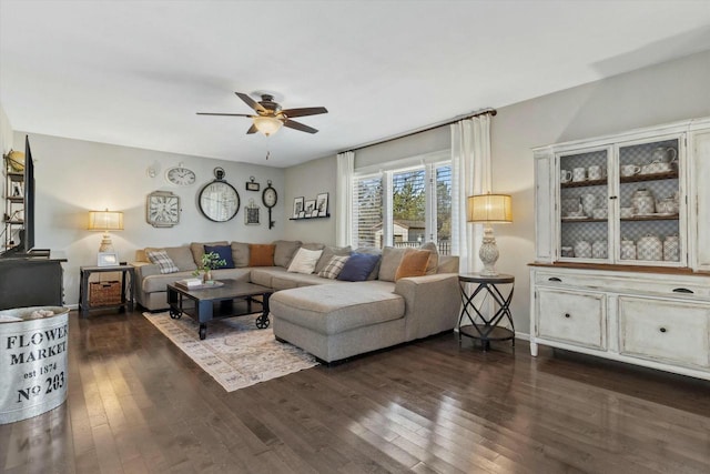 living area with a ceiling fan and dark wood-style flooring