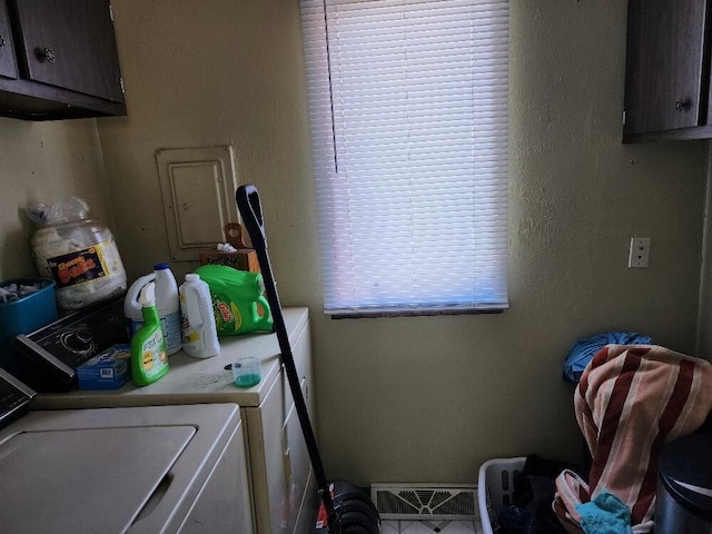 washroom with washer and dryer, visible vents, and cabinet space