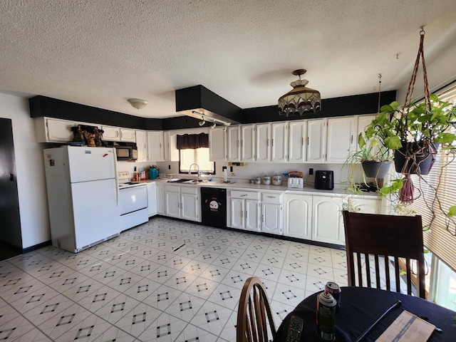 kitchen featuring white cabinetry, black appliances, light countertops, and a sink