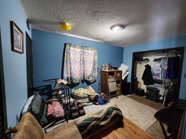 bedroom featuring a textured ceiling and carpet