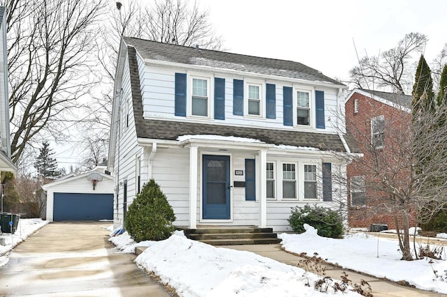 view of front of house with a garage, a shingled roof, and an outdoor structure