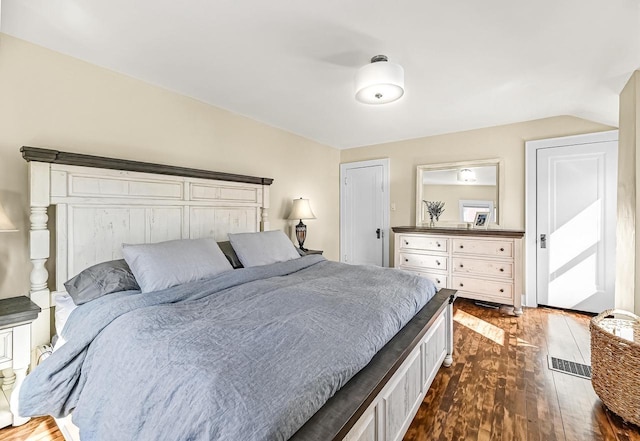 bedroom with dark wood-style flooring