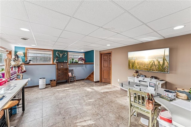 interior space with tile patterned floors, a drop ceiling, recessed lighting, baseboards, and stairs