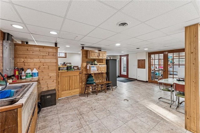 kitchen featuring visible vents, baseboards, recessed lighting, a drop ceiling, and french doors