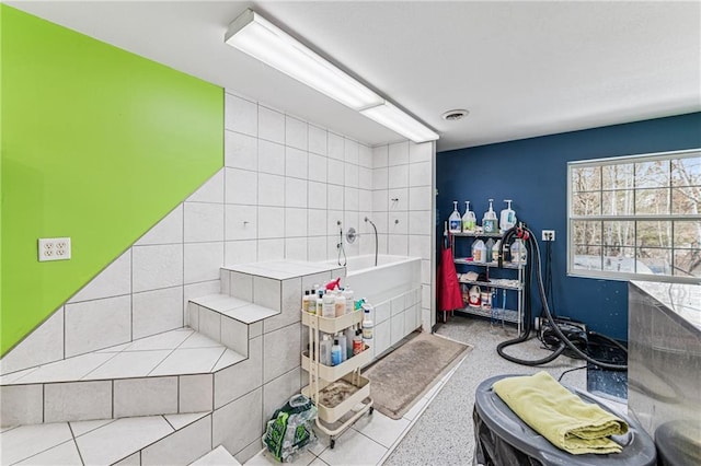 full bath featuring a bath, visible vents, and speckled floor