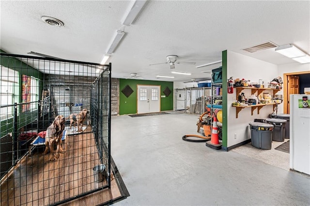 garage featuring baseboards, visible vents, and ceiling fan