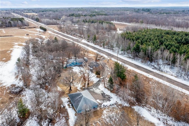 snowy aerial view featuring a view of trees