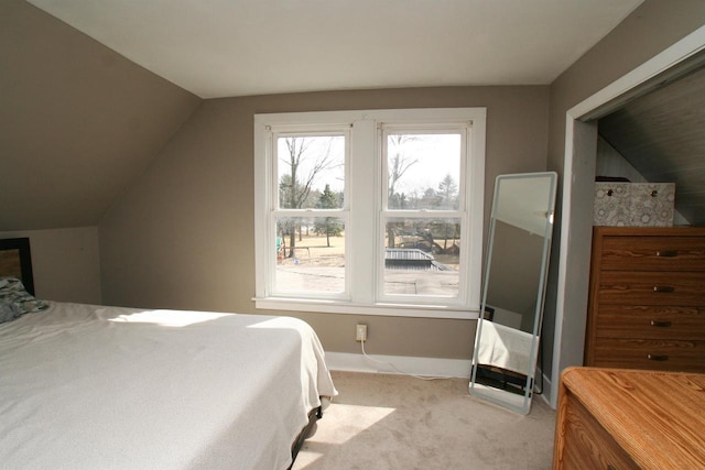 bedroom with lofted ceiling and light colored carpet