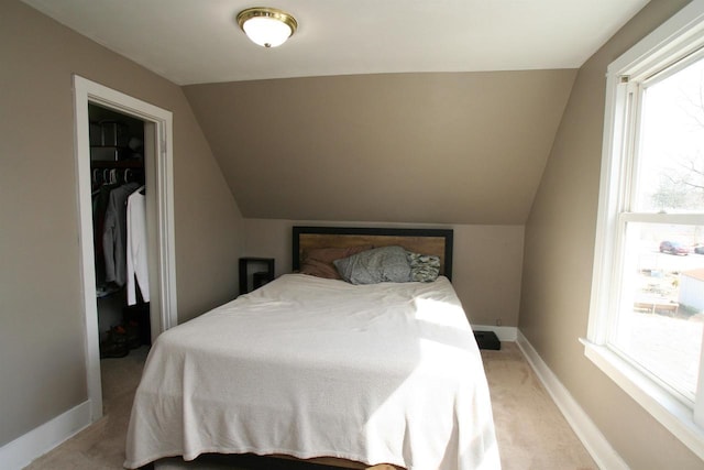 bedroom with baseboards, multiple windows, light carpet, and vaulted ceiling