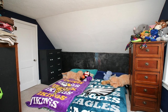 carpeted bedroom with vaulted ceiling