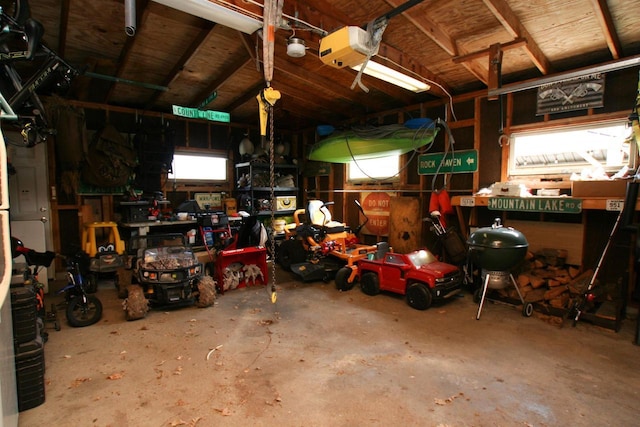 garage with a workshop area and a garage door opener