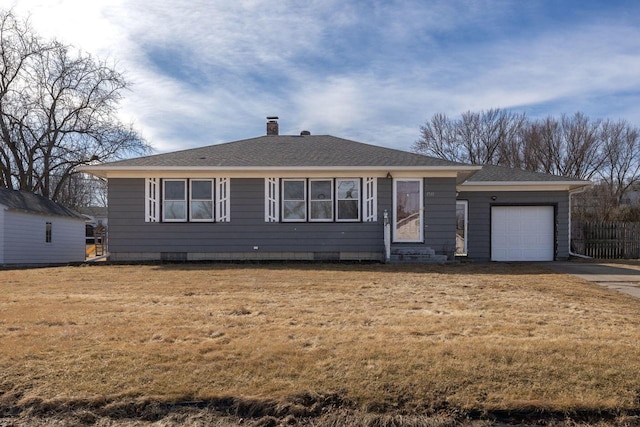 single story home featuring a front yard, roof with shingles, an attached garage, a chimney, and concrete driveway