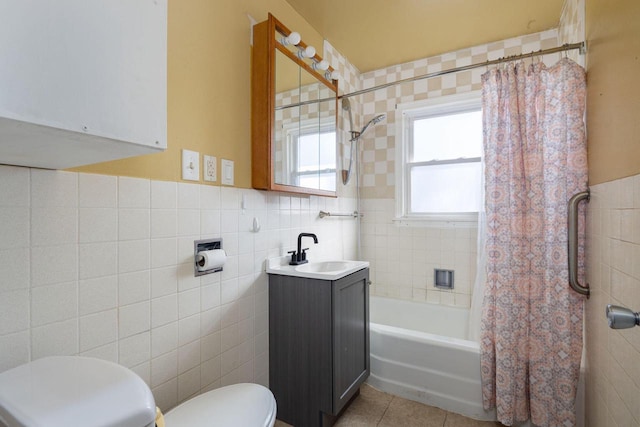 full bathroom featuring tile patterned floors, toilet, shower / bath combo, tile walls, and vanity