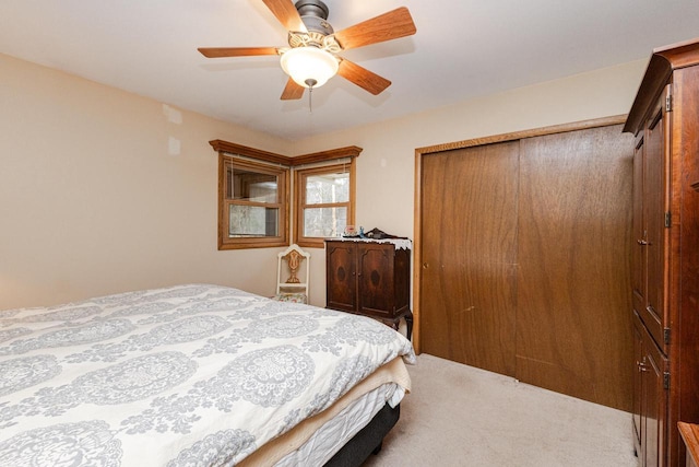 carpeted bedroom featuring a closet and ceiling fan