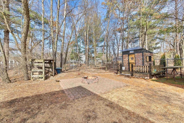 view of yard with a wooden deck, an outdoor fire pit, and fence