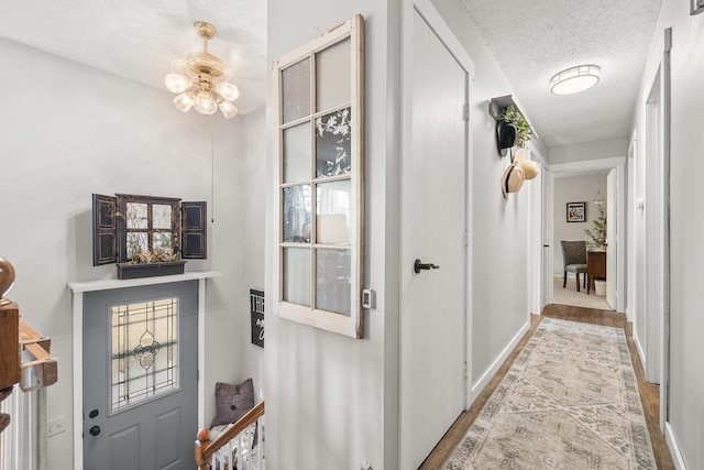 interior space with baseboards and a textured ceiling