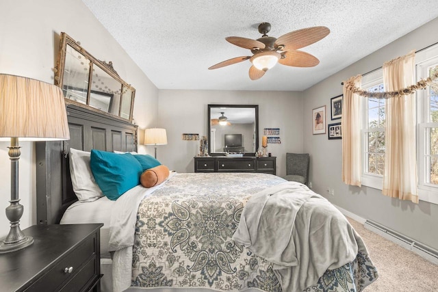 bedroom featuring a baseboard heating unit, a textured ceiling, ceiling fan, and carpet flooring