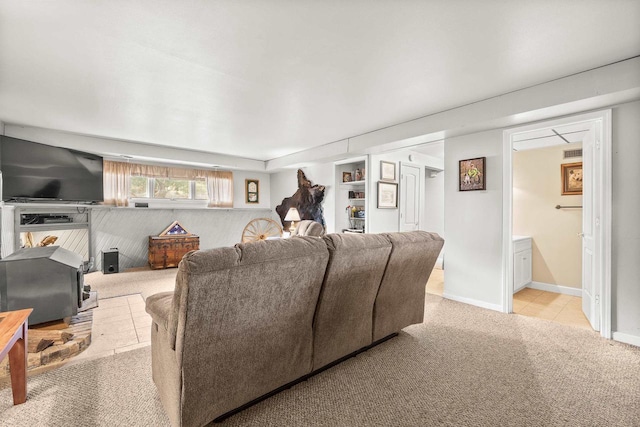 living area featuring baseboards and carpet