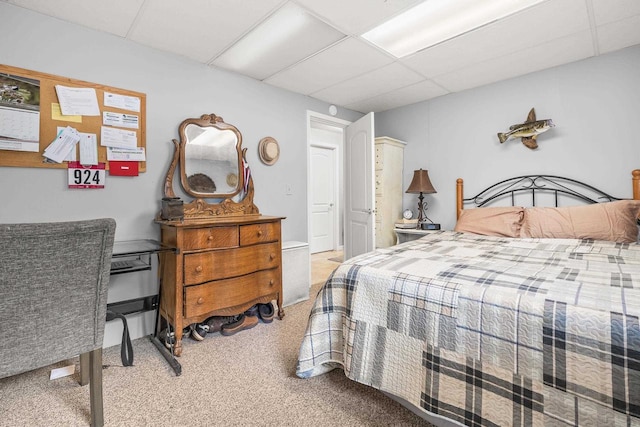 carpeted bedroom featuring a paneled ceiling