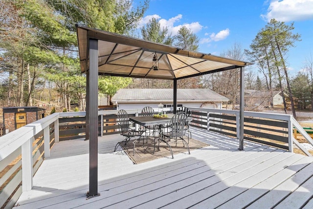 deck with a gazebo and outdoor dining area