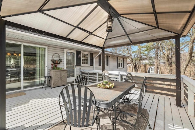 wooden terrace featuring outdoor dining area