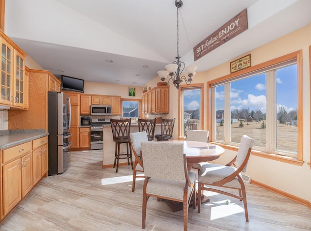 dining space with baseboards, recessed lighting, vaulted ceiling, light wood-style floors, and a notable chandelier