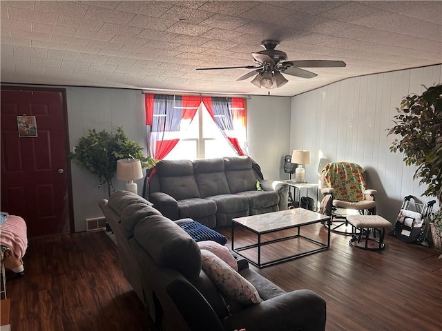 living room with a ceiling fan, wood finished floors, and visible vents