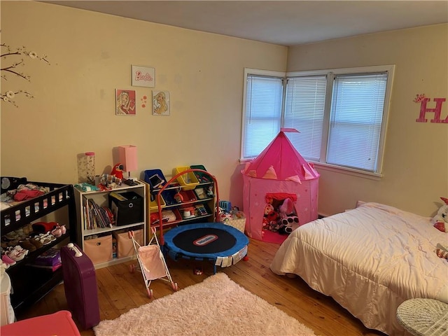 bedroom with hardwood / wood-style floors