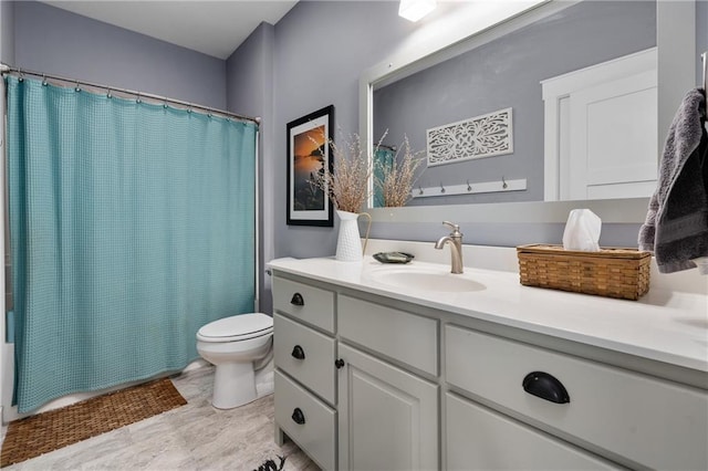 bathroom with shower / bath combo with shower curtain, toilet, and vanity