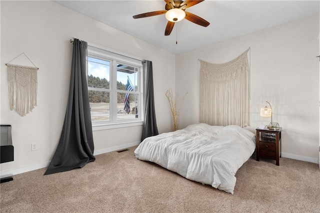 bedroom featuring a ceiling fan, carpet, visible vents, and baseboards