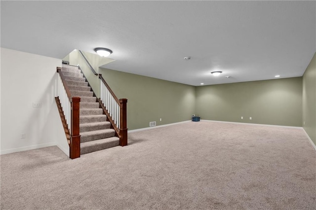 finished below grade area featuring visible vents, baseboards, stairs, carpet floors, and recessed lighting