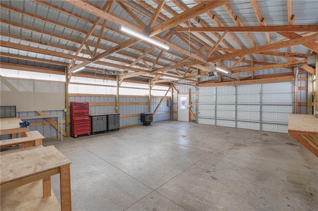 garage featuring a garage door opener and metal wall