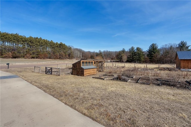 view of yard featuring an outdoor structure and fence