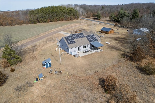 birds eye view of property featuring a rural view and a forest view