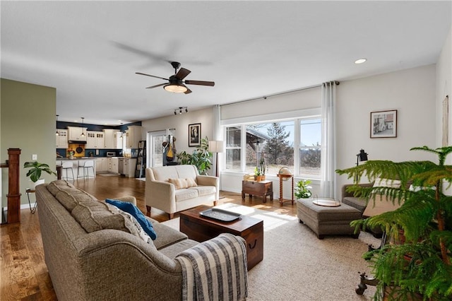 living room featuring recessed lighting, baseboards, wood finished floors, and ceiling fan