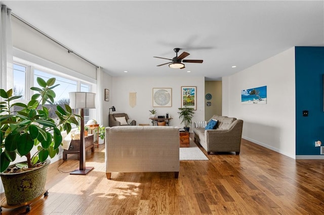 living area featuring recessed lighting, ceiling fan, baseboards, and wood finished floors