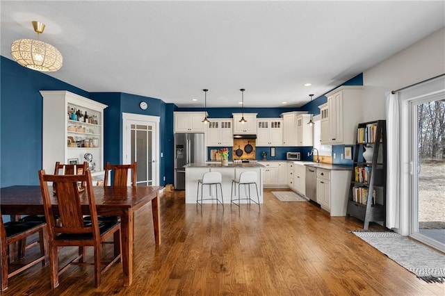 dining area with recessed lighting and dark wood-style flooring