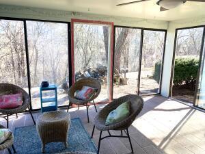 sunroom / solarium with a wealth of natural light and ceiling fan